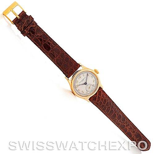 The image shows a top view of a Vintage Patek Philippe watch, displaying the face, dial, and brown leather strap.