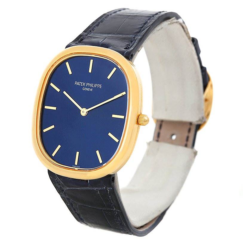 The image shows a side-angle view of the Patek Philippe Golden Ellipse 3738 Men's Yellow Gold Blue Dial 3738 Men's Yellow Gold Blue Dial watch, highlighting the face, bezel, crown, and strap.