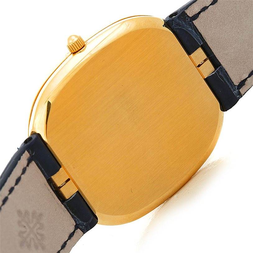 The image shows the back case and crown of the Patek Philippe Golden Ellipse 3738 Men's Yellow Gold Blue Dial 3738 Men's Yellow Gold Blue Dial watch, viewed from an angle.