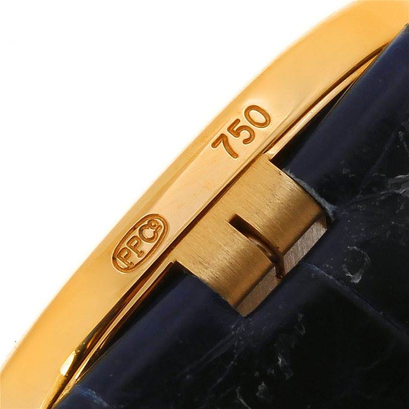 This image shows a close-up of the clasp and part of the band of the Patek Philippe Golden Ellipse 3738 Men's Yellow Gold Blue Dial 3738 Men's Yellow Gold Blue Dial watch, focusing on the gold hallmark.