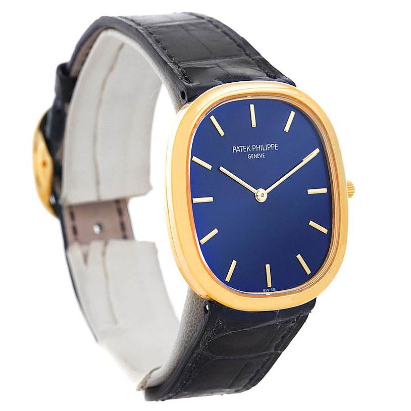This image shows a Patek Philippe Golden Ellipse 3738 Men's Yellow Gold Blue Dial 3738 Men's Yellow Gold Blue Dial watch at a slight side angle, highlighting its blue dial, golden case, and black strap.