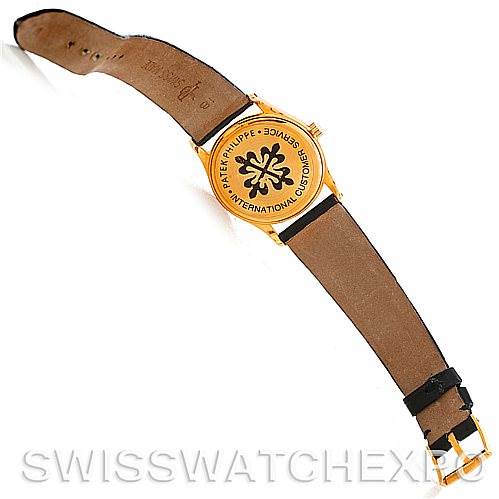 The image shows the back and strap of a Patek Philippe Calatrava 3796 Men's Yellow Gold White Dial 3796 Men's Yellow Gold White Dial watch from a top-down angle.