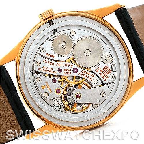 The image shows the back of a Patek Philippe Calatrava 3796 Men's Yellow Gold White Dial 3796 Men's Yellow Gold White Dial watch, displaying its intricate mechanical movement and inner components.