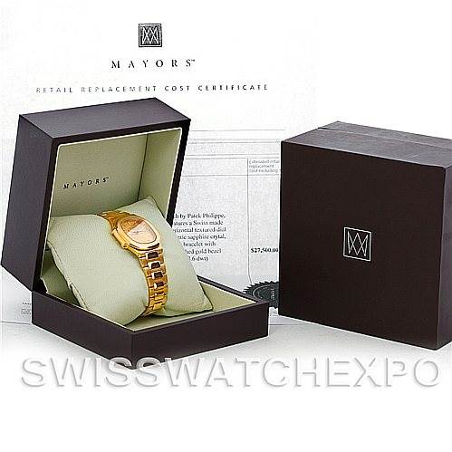 The image shows a Patek Philippe Nautilus 3900/1J Men's Yellow Gold Champagne Dial 3900/1J Men's Yellow Gold Champagne Dial watch in a display box, accompanied by its certificate.