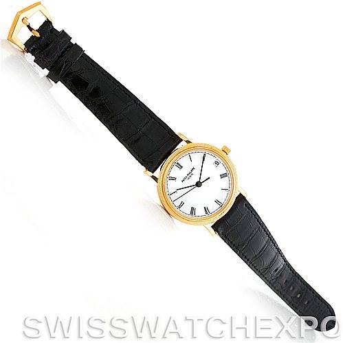 The image shows a Patek Philippe Calatrava 3802 Men's Yellow Gold White Dial 3802 Men's Yellow Gold White Dial watch from a top-down angle, featuring a gold case, white dial, Roman numerals, and black leather strap.