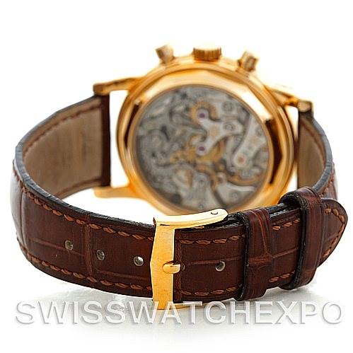 The image shows the back view of the Patek Philippe 3970 Men's Yellow Gold Silver Dial 3970 Men's Yellow Gold Silver Dial 3970 model, highlighting its intricate mechanism and leather strap with a gold buckle.