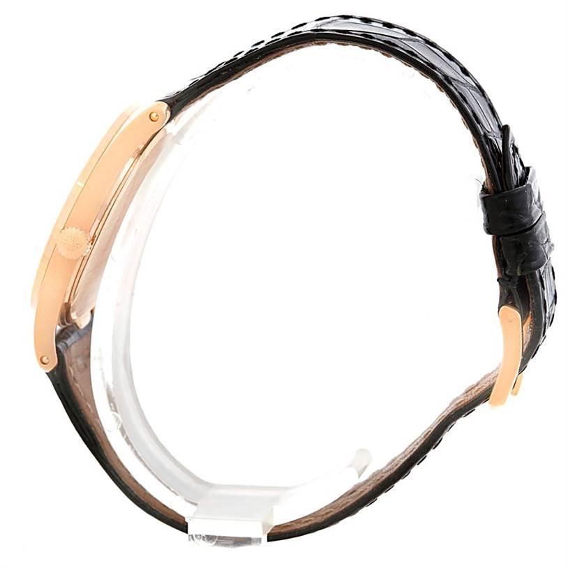 The image shows a side view of the Vintage Patek Philippe watch with a black leather strap and gold case.