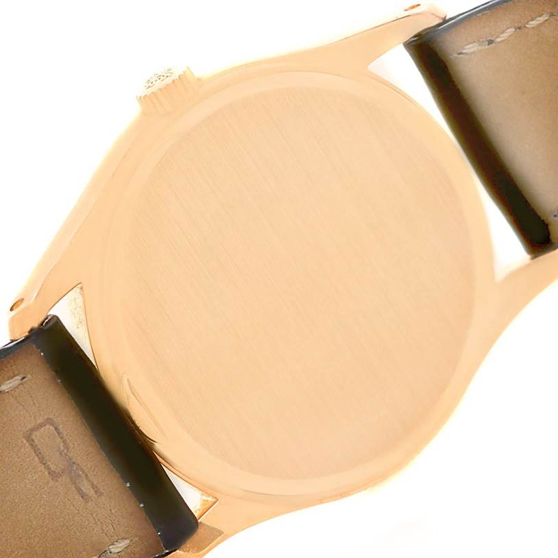 The image shows the back case and crown of a vintage Patek Philippe watch from a rear angle.