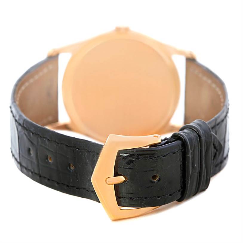 The image shows the back of a Patek Philippe Vintage 3796 Men's Rose Gold Silver Dial 3796 Men's Rose Gold Silver Dial watch, highlighting its black leather strap and gold buckle.