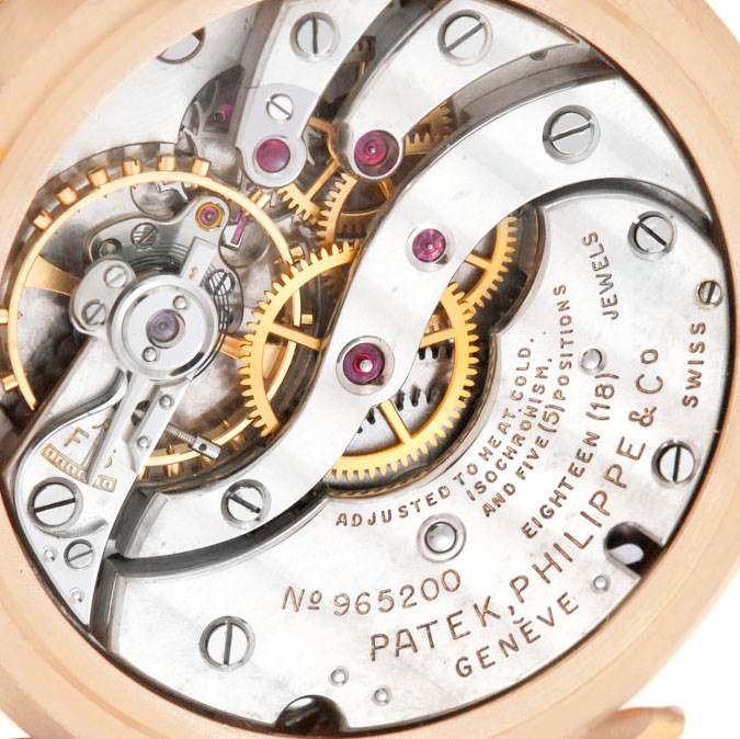 This image shows the detailed movement mechanism of a Vintage Patek Philippe watch, highlighting gears and jewels.
