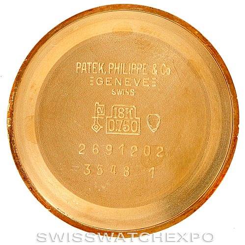 The image shows the inner case back of a Patek Philippe Golden Ellipse 3548/1 Men's Yellow Gold Blue Dial 3548/1 Men's Yellow Gold Blue Dial watch, highlighting the brand, gold hallmark, and serial numbers.