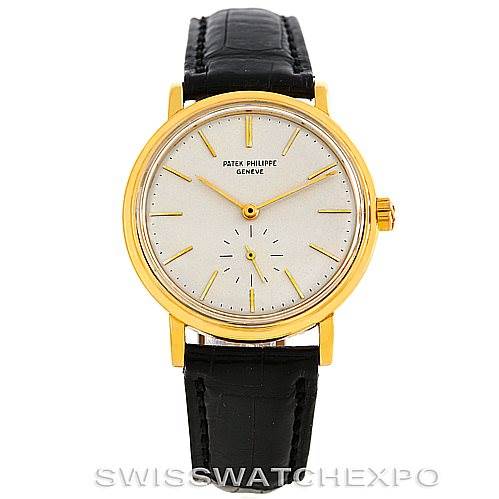 This image shows a front view of a Vintage Patek Philippe watch with a gold case, white dial, and black leather strap.