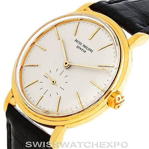 The vintage Patek Philippe watch is shown at an angled view, highlighting its gold case, dial, and black leather strap.