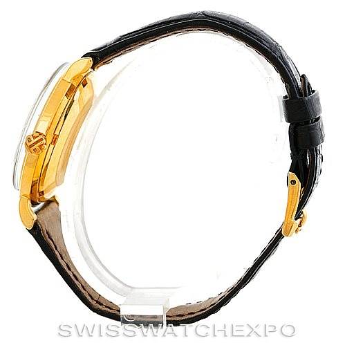 The image shows a side view of a Vintage Patek Philippe watch, highlighting its gold case and black leather strap.