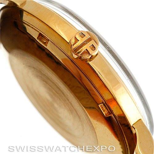 The image shows a side view of a vintage Patek Philippe watch, highlighting the gold case and the crown with the PP logo.