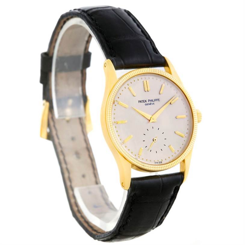 The Patek Philippe Calatrava 3796 Men's Yellow Gold Silver Dial 3796 Men's Yellow Gold Silver Dial watch is shown at a slight angle, highlighting its gold casing, black leather strap, and dial.