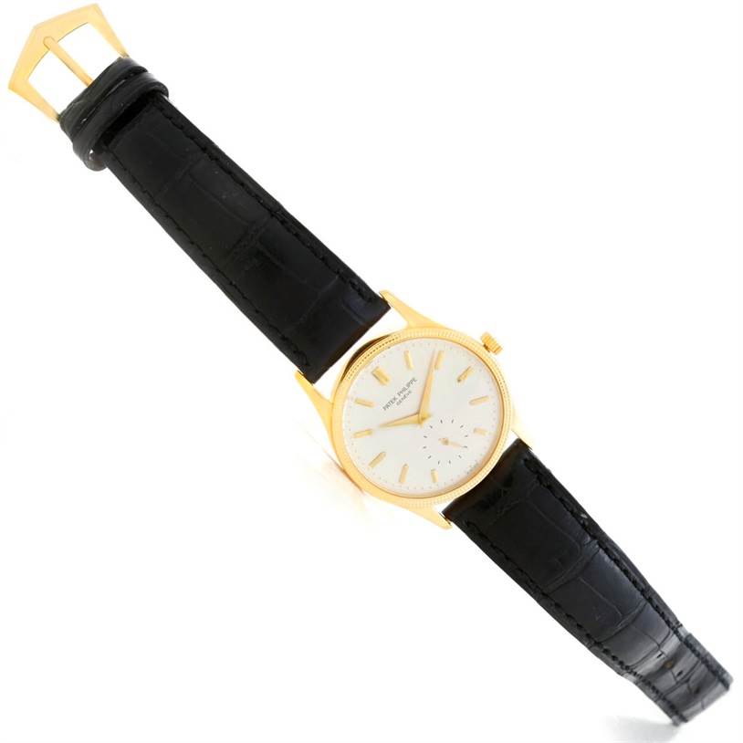 This image shows a Patek Philippe Calatrava 3796 Men's Yellow Gold Silver Dial 3796 Men's Yellow Gold Silver Dial watch at an angled top view, highlighting its face, strap, and buckle.