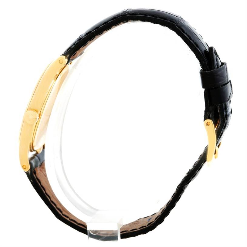 The image shows a side view of the Patek Philippe Calatrava 3796 Men's Yellow Gold Silver Dial 3796 Men's Yellow Gold Silver Dial watch, featuring its gold case, crown, and black leather strap.