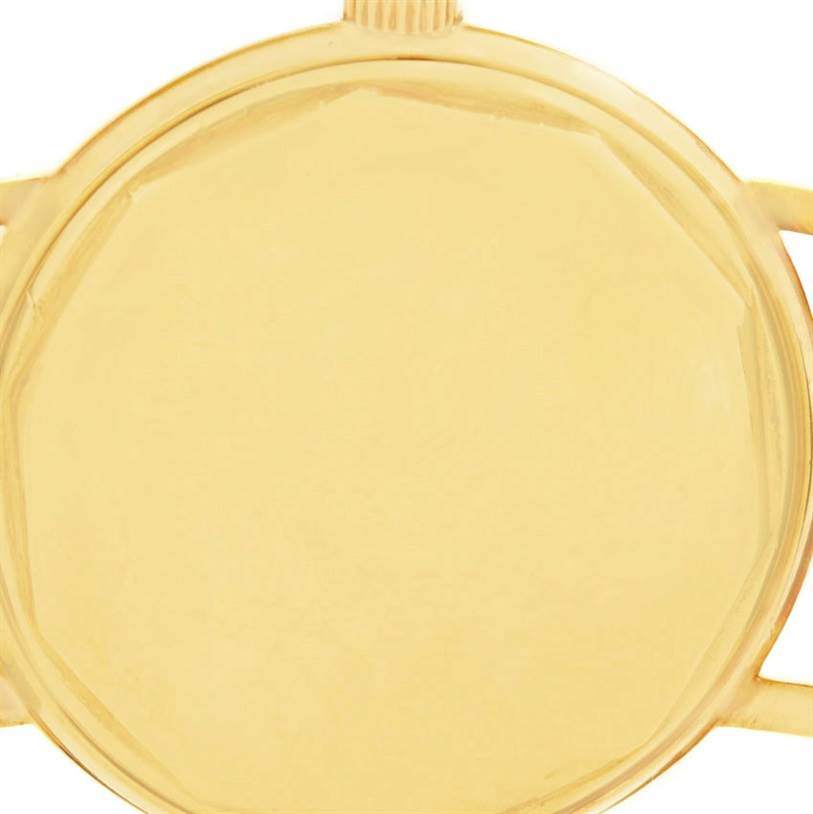 This image shows a close-up of the case back and crown of a Vintage Patek Philippe watch, viewed from the rear.