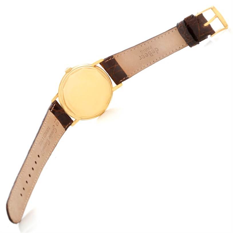 This image shows the back view of a Vintage Patek Philippe watch with a gold case and brown leather strap.