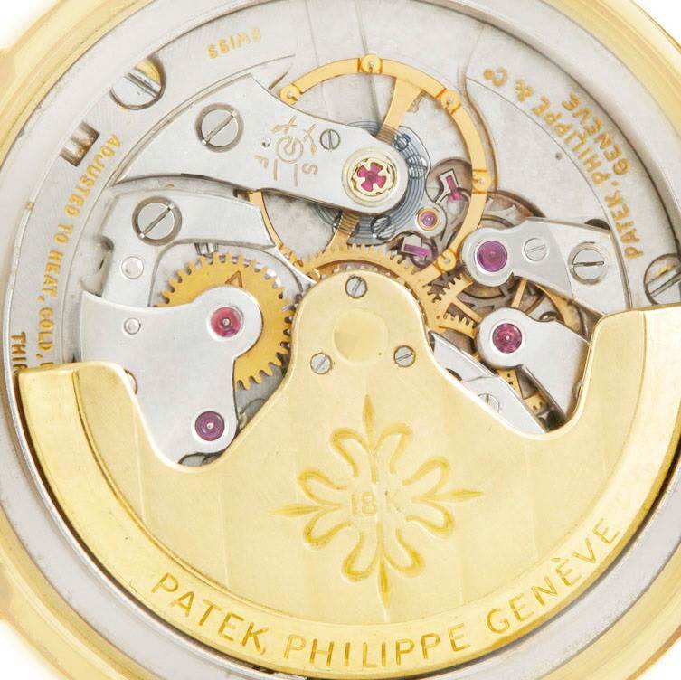 It's a close-up view of the movement mechanism of a Vintage Patek Philippe watch, showcasing gears and the rotor.