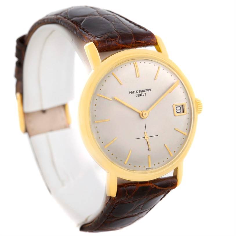 The image shows a Patek Philippe Vintage 3445 Men's Yellow Gold Silver Dial 3445 Men's Yellow Gold Silver Dial model watch at an angle displaying the face, golden case, and brown leather strap.
