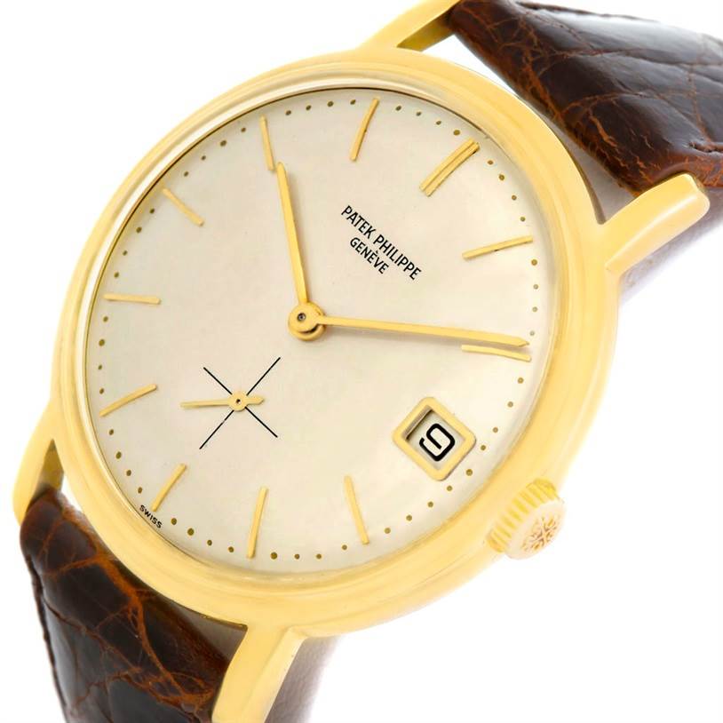 This image shows a Vintage Patek Philippe watch from an angled view, highlighting the dial, case, crown, and part of the leather strap.