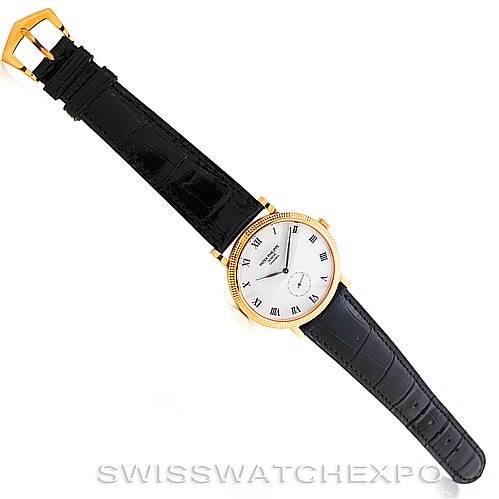 The image shows a top-down view of a Patek Philippe Calatrava 3919 Men's Yellow Gold White Dial 3919 Men's Yellow Gold White Dial watch, clearly displaying the entire watch and black strap.