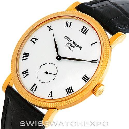 The image shows a close-up, angled view of a Patek Philippe Calatrava 3919 Men's Yellow Gold White Dial 3919 Men's Yellow Gold White Dial watch, highlighting its face, case, and part of the leather strap.