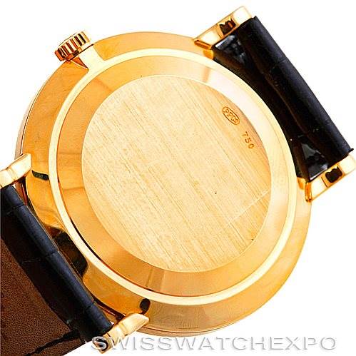 The image shows the back case and lugs of a Patek Philippe Calatrava 3919 Men's Yellow Gold White Dial 3919 Men's Yellow Gold White Dial watch, focusing on its gold-colored casing and black leather straps.