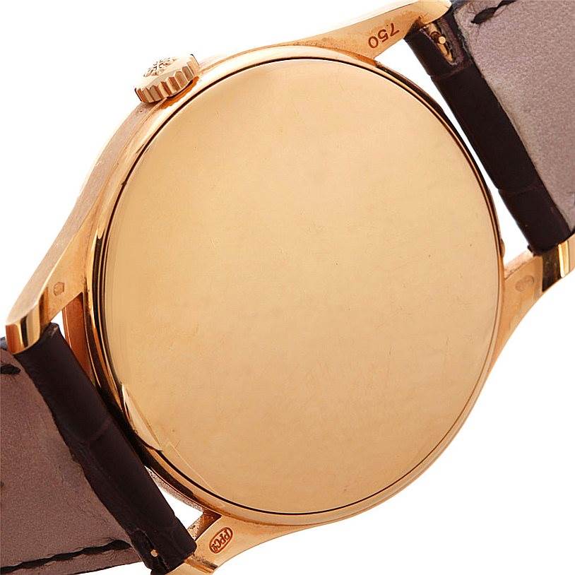 The image shows the back case, crown, and leather straps of the Patek Philippe Calatrava 5196R Men's Rose Gold Silver Dial 5196R Men's Rose Gold Silver Dial watch.