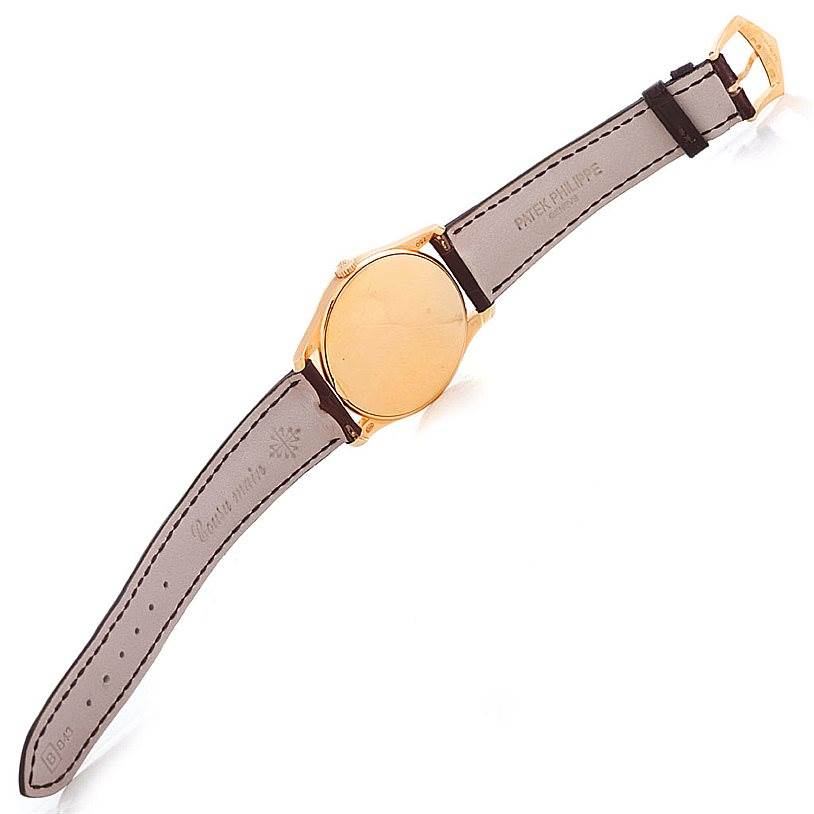The image shows the back view of a Patek Philippe Calatrava 5196R Men's Rose Gold Silver Dial 5196R Men's Rose Gold Silver Dial watch, highlighting the leather strap and closed case back.