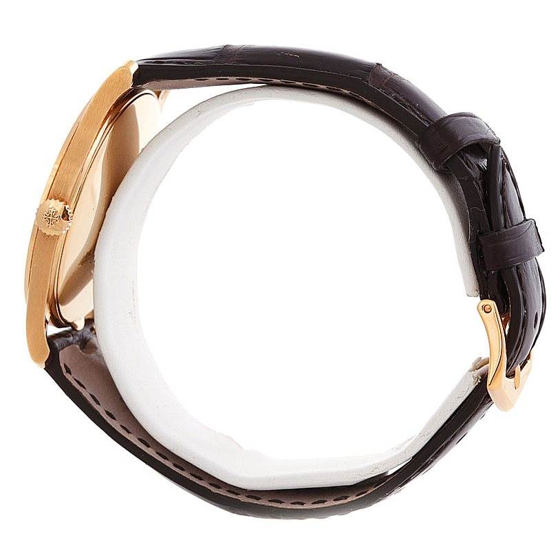 The image displays a side view of a Patek Philippe Calatrava 5196R Men's Rose Gold Silver Dial 5196R Men's Rose Gold Silver Dial watch showing the case, crown, and leather strap.