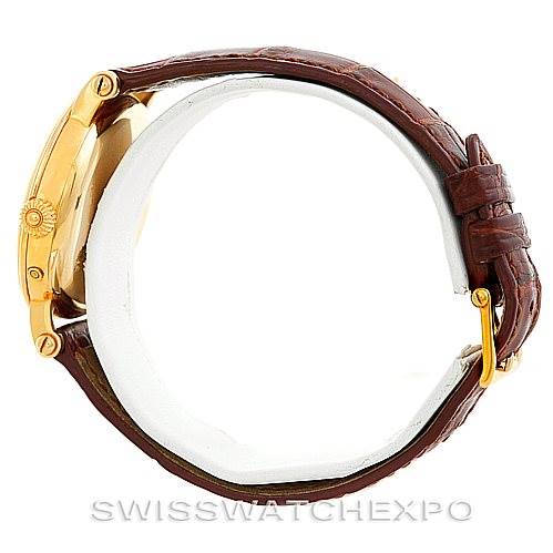 This image shows a side view of the Patek Philippe Complications 5054 Men's Yellow Gold White Dial 5054 Men's Yellow Gold White Dial watch, highlighting the gold case and brown leather strap.