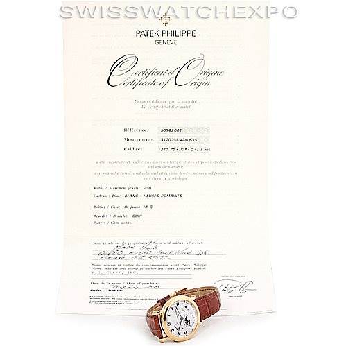 The image shows a Patek Philippe Complications 5054 Men's Yellow Gold White Dial 5054 Men's Yellow Gold White Dial watch placed in front of its Certificate of Origin document.