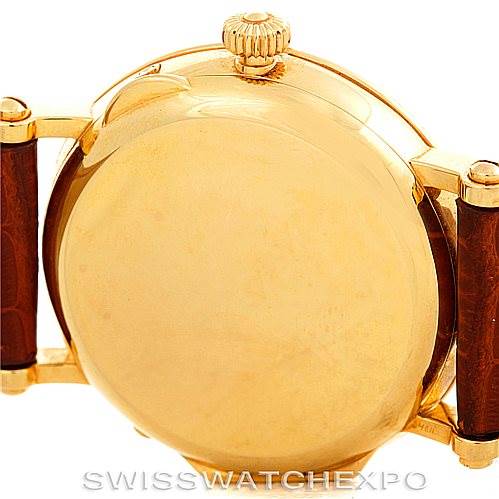 The image shows the back case and crown of a Patek Philippe Complications 5054 Men's Yellow Gold White Dial 5054 Men's Yellow Gold White Dial watch.