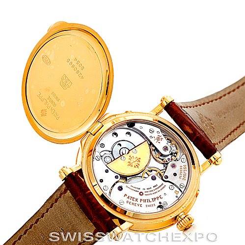 The image shows the back view of the Patek Philippe Complications 5054 Men's Yellow Gold White Dial 5054 Men's Yellow Gold White Dial watch, with its case back open, revealing the intricate movement inside.