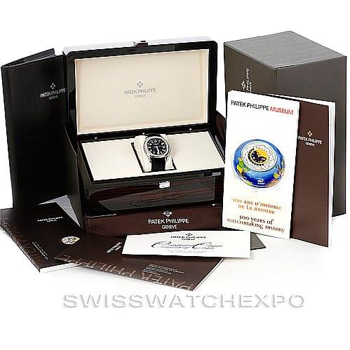 The Patek Philippe Aquanaut 5167A Men's Stainless Steel Black Dial 5167A Men's Stainless Steel Black Dial watch is shown from the front, alongside its box, booklets, and other accessories.
