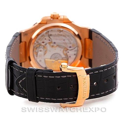 This image shows the back view of a Patek Philippe Nautilus 5712R Men's Rose Gold  5712R Men's Rose Gold  watch, focusing on the open case back and black leather strap with a gold buckle.