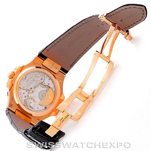 The image shows the back view of a Patek Philippe Nautilus 5712R Men's Rose Gold  5712R Men's Rose Gold  watch, highlighting the open clasp and internal mechanics.