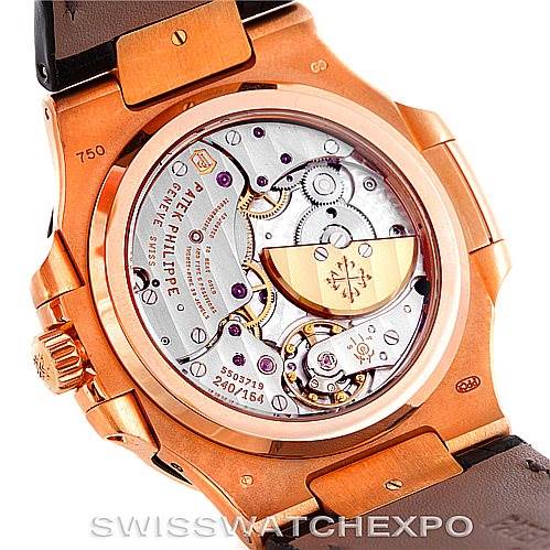 The image shows the back view of a Patek Philippe Nautilus 5712R Men's Rose Gold  5712R Men's Rose Gold  watch, highlighting its intricate mechanical movement and inner components.