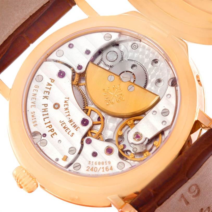 The image shows the back view of the Patek Philippe 5054 Men
s Rose Gold White Dial 5054 Men
s Rose Gold White Dial Power Reserve Moonphase Rose Gold Watch 5054 Papers, featuring its intricate movement.