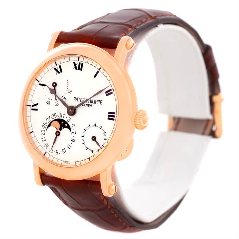 The Patek Philippe 5054 Men
s Rose Gold White Dial 5054 Men
s Rose Gold White Dial Power Reserve Moonphase Rose Gold Watch 5054 is shown at an angle highlighting the dial, case, crown, and strap.