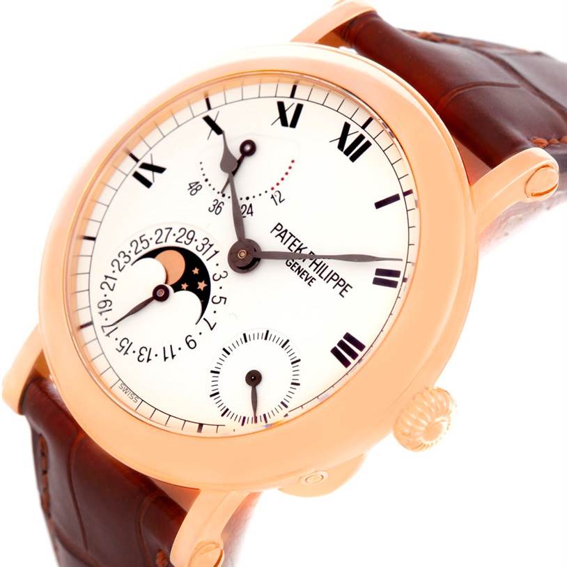 The image shows a Patek Philippe 5054 Men
s Rose Gold White Dial 5054 Men
s Rose Gold White Dial Power Reserve Moonphase Rose Gold Watch 5054 Papers model, angled to highlight the face, dial, and part of the strap.