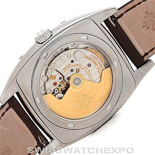 The image shows the back view of the Patek Philippe 5135G Men's White Gold Black Dial 5135G Men's White Gold Black Dial Complicated Annual Calendar Men's Watch 5135G, highlighting its automatic movement and rotor.