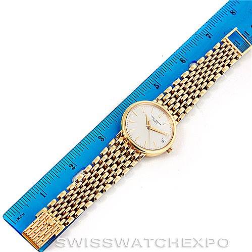 This image shows an overhead view of a Patek Philippe Calatrava 3998 Men's Yellow Gold Silver Dial 3998 Men's Yellow Gold Silver Dial watch, including its face, case, and full metal bracelet with a ruler for scale.