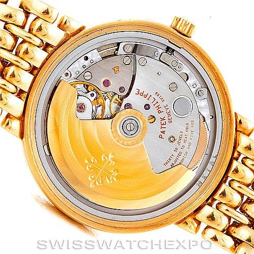 The image shows the back view of a Patek Philippe Calatrava 3998 Men's Yellow Gold Silver Dial 3998 Men's Yellow Gold Silver Dial watch, highlighting its intricate mechanical movement and gold components.