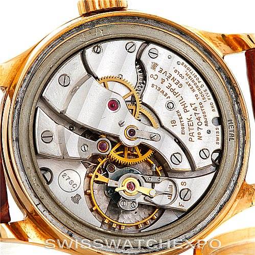 The image shows the back view of a Vintage Patek Philippe watch, highlighting its internal mechanical movement.