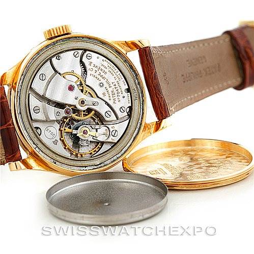 The image shows the open case back of a Vintage Patek Philippe watch, revealing its intricate mechanical movement.