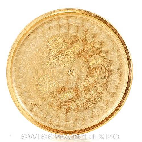 This image shows the inside case back of a vintage Patek Philippe watch, featuring various engravings and hallmarks.